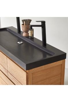 a bathroom sink sitting on top of a wooden cabinet