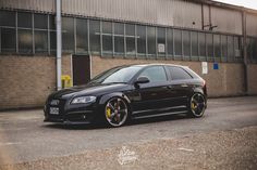 a black car parked in front of a building