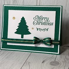 a christmas card with a green bow on it