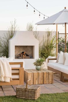 an outdoor fireplace in the middle of a patio