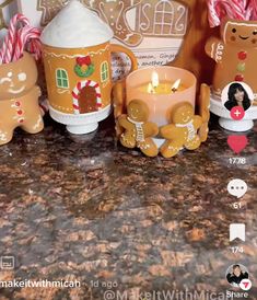 some gingerbread candles are sitting on a counter with candy canes and other decorations