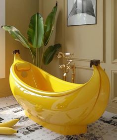 a large banana shaped bathtub sitting on top of a floor next to a plant