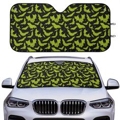 the front and back of a car with green bats on it