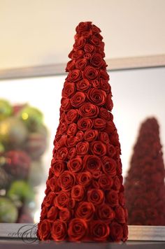 red roses are arranged in the shape of a cone on top of a countertop