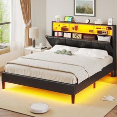 a bed that has some lights on the headboard and foot board in front of it