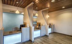 an empty office with wooden floors and white walls