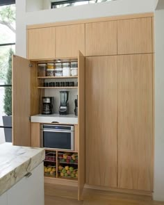 a kitchen with wooden cabinets and white counter tops