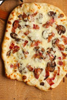 a pizza sitting on top of a wooden cutting board