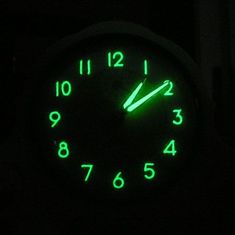 a clock with green numbers in the dark