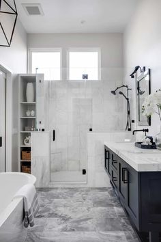 a bathroom with marble floors and white walls, along with a large tub in the center