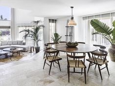 a living room filled with furniture and plants