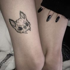 two women with tattoos on their legs and one has a dog's head tattoo