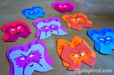 colorful paper cut outs with faces on them