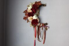 dried flowers and leaves hang on the wall