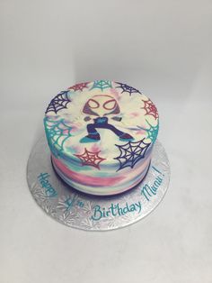 a birthday cake is decorated with spider webs