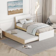 a bed that is sitting on top of a hard wood floor in a room with white walls