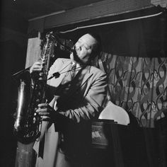 black and white photograph of man playing saxophone