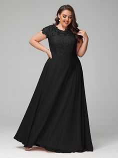 a woman in a long black dress with lace detailing on the top and sleeves, posing for