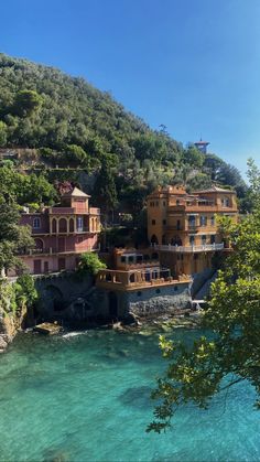 houses on the side of a cliff overlooking water