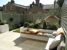 an outdoor seating area in the middle of a garden