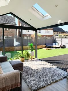 a living room filled with furniture and a skylight