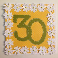 a yellow and white greeting card with the number 50 on it's front, surrounded by daisies