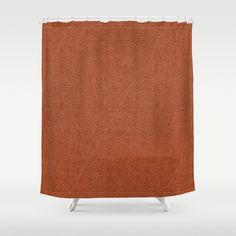 a brown shower curtain with an orange pattern on the bottom and white trimmings