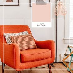 an orange chair sitting in a living room next to a wall with pictures on it