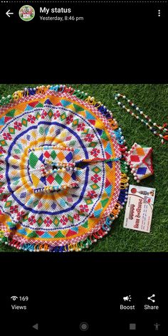 an image of a multicolored round rug on the ground with beads and pins