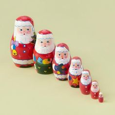 a row of santa claus figurines sitting next to each other