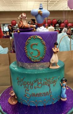 a birthday cake that is decorated with figurines