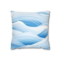 a blue and white pillow with waves on it