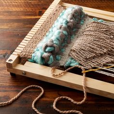 an old weaving loom with yarn and needles