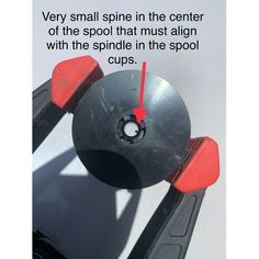 a pair of black and red pliers on top of a white surface with the words very small spin in the center of the spool that must align with the spiel in the pool cup