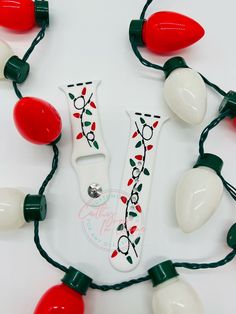 a string of christmas lights with the letter v on it's side and red, white and green lights attached to them