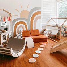 a living room filled with furniture and lots of wood flooring next to a window