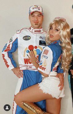 a man and woman dressed in racing gear