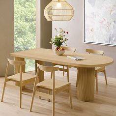 a dining room table with chairs and a vase on the table in front of it