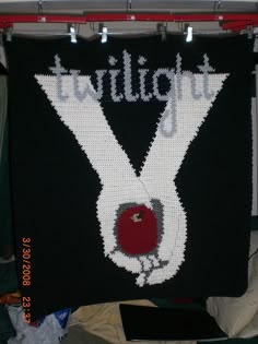 a black and white knitted sign with the words twilight written in red on it