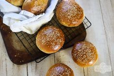 small buns with sesame seeds on a cooling rack