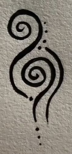 a black and white drawing on the side of a wall with a spiral design in it