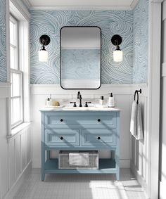 a bathroom vanity with two sinks and a large mirror above it in front of a window