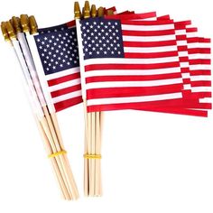 four american flags are lined up on top of each other, with gold sticks sticking out of them