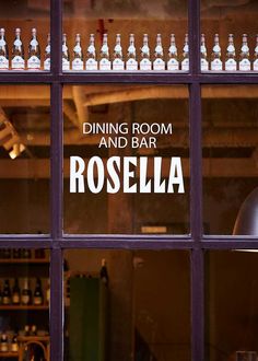 there is a sign that says dining room and bar rosella in front of the window