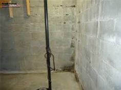 a black and white cat laying on the floor next to a shower