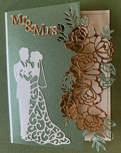 a wedding card with the silhouettes of a bride and groom on top of each other