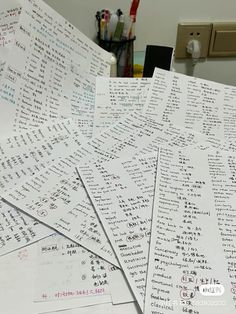 many sheets of paper with writing on them