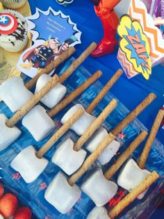 an assortment of ice cubes and marshmallows on a blue tablecloth