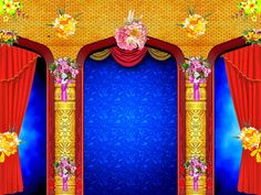 an open stage with red curtains and flowers