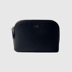 the black leather makeup bag is shown with gold initials on the front and bottom side